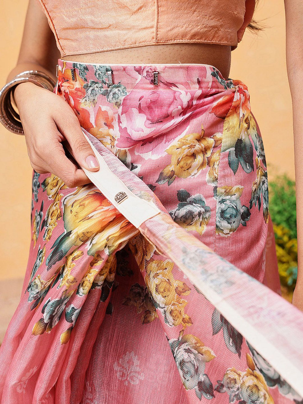 Person wearing a floral pink saree
